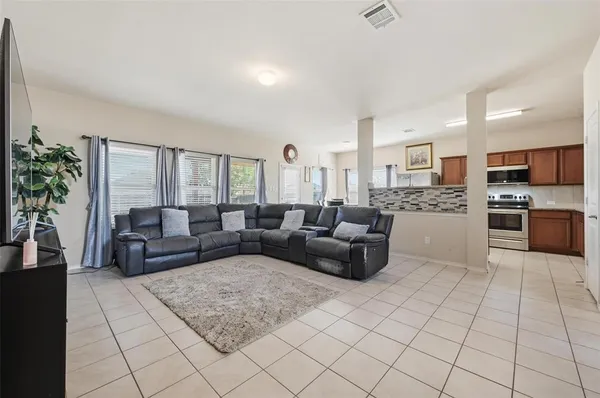 a living room with furniture and a large window