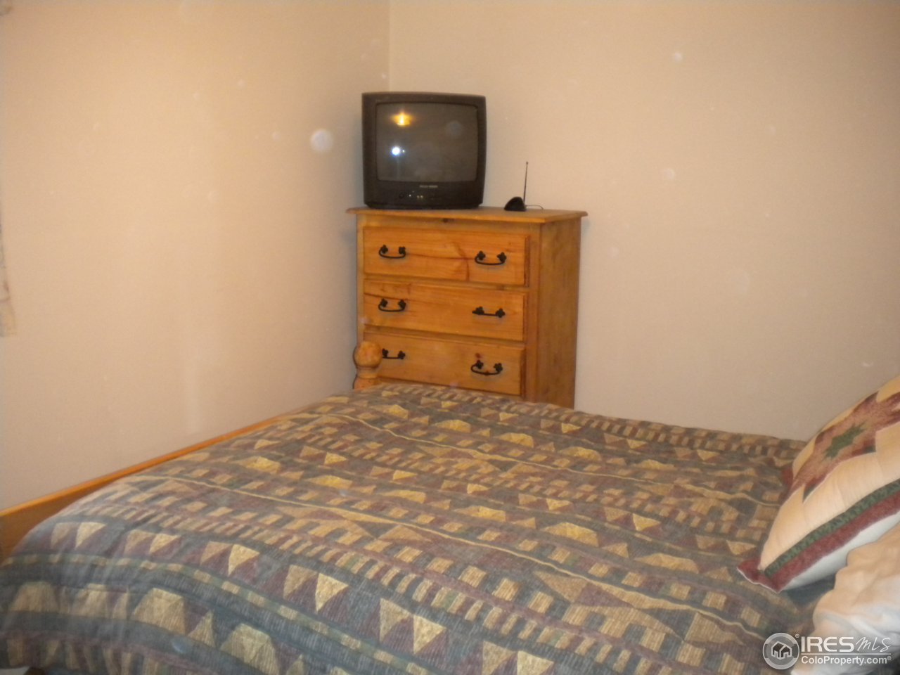 2834 Riverside Drive Lyons, CO 80540 - Photo 10 of 13 a bedroom with a bed and a television
