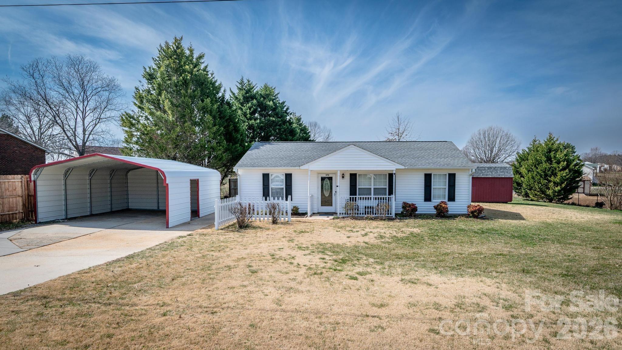 370 Weathers Creek Road Troutman, NC 28166 - Photo 2 of 10 a house with trees in front of it
