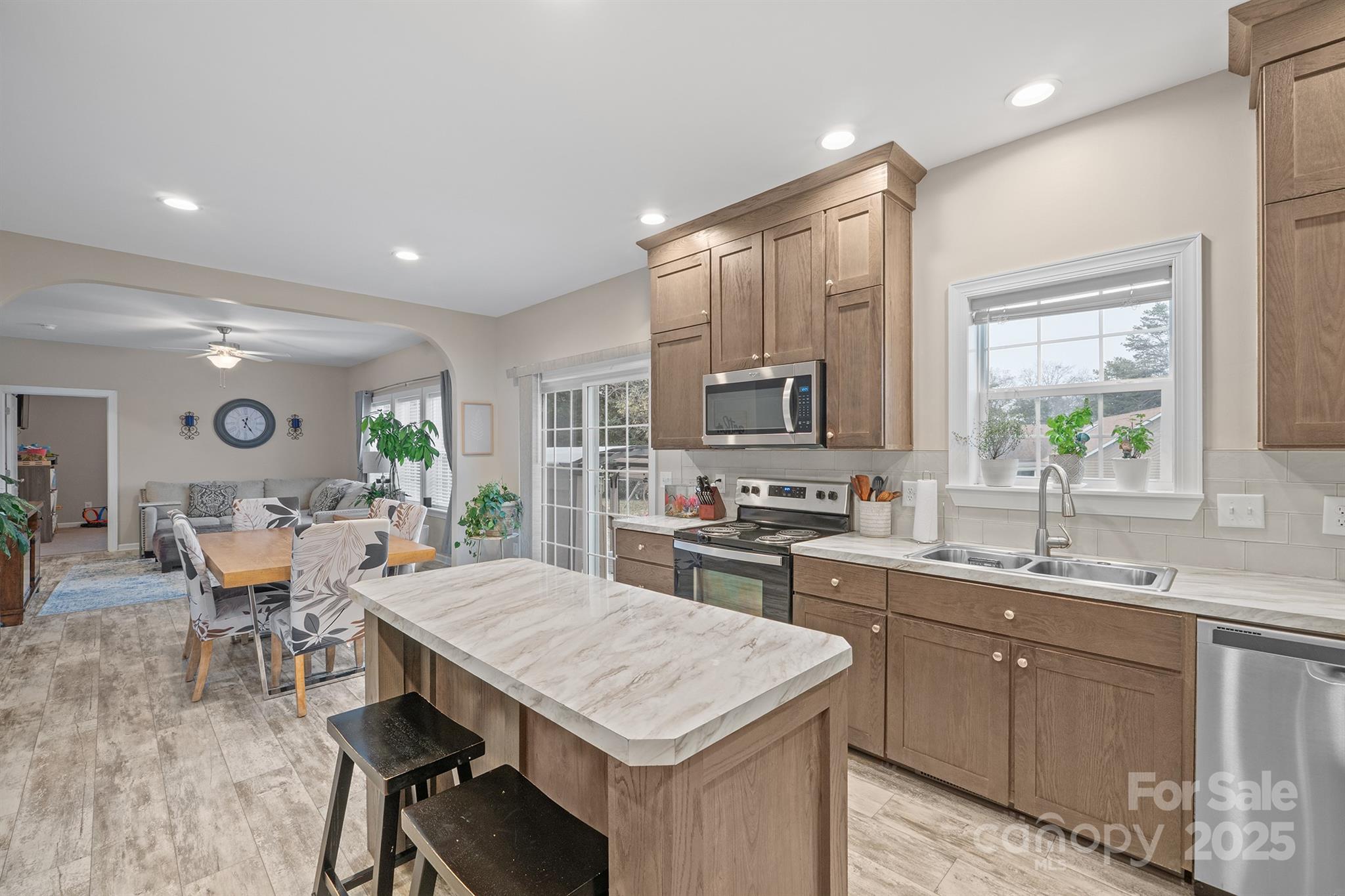 486 Stutts Road Mooresville, NC 28117 - Photo 11 of 35 a kitchen with a table chairs sink and cabinets