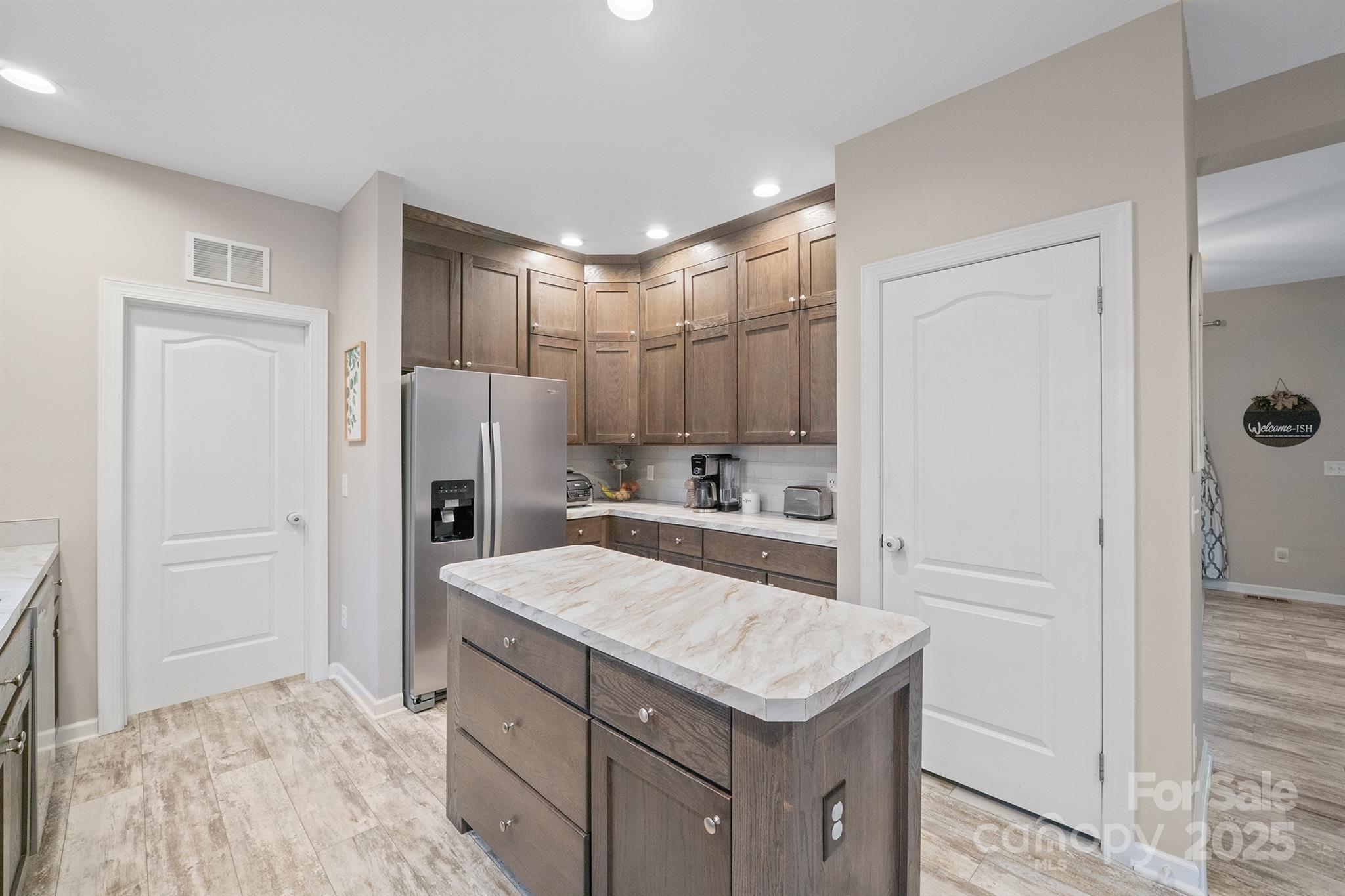 486 Stutts Road Mooresville, NC 28117 - Photo 13 of 35 a kitchen with a refrigerator a sink and cabinets