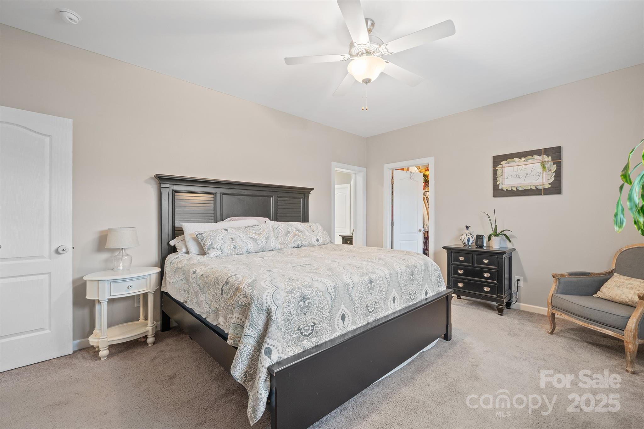 486 Stutts Road Mooresville, NC 28117 - Photo 20 of 35 a bedroom with a bed and a chandelier