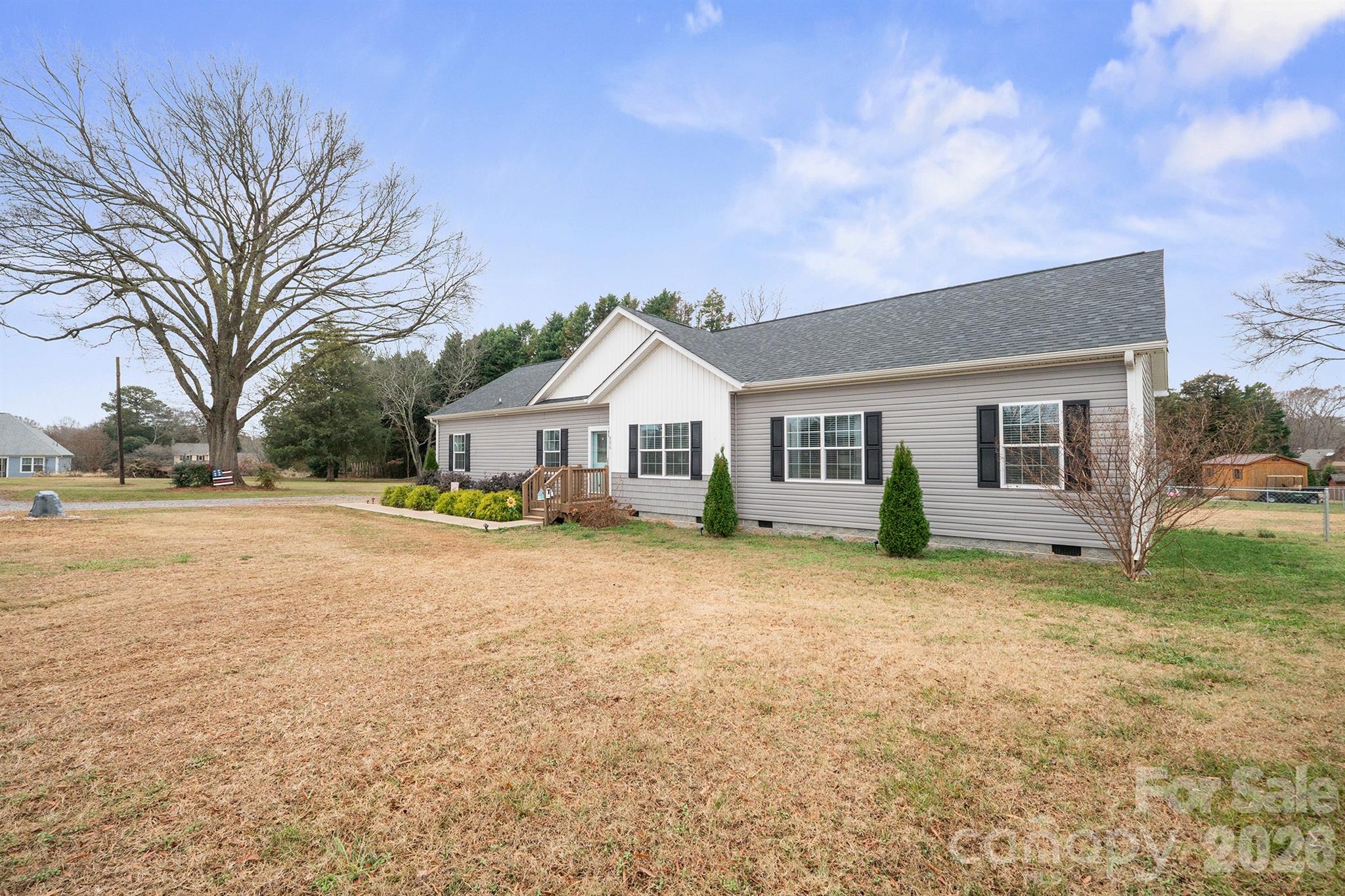 486 Stutts Road Mooresville, NC 28117 - Photo 2 of 35 a front view of house with yard and trees in the background