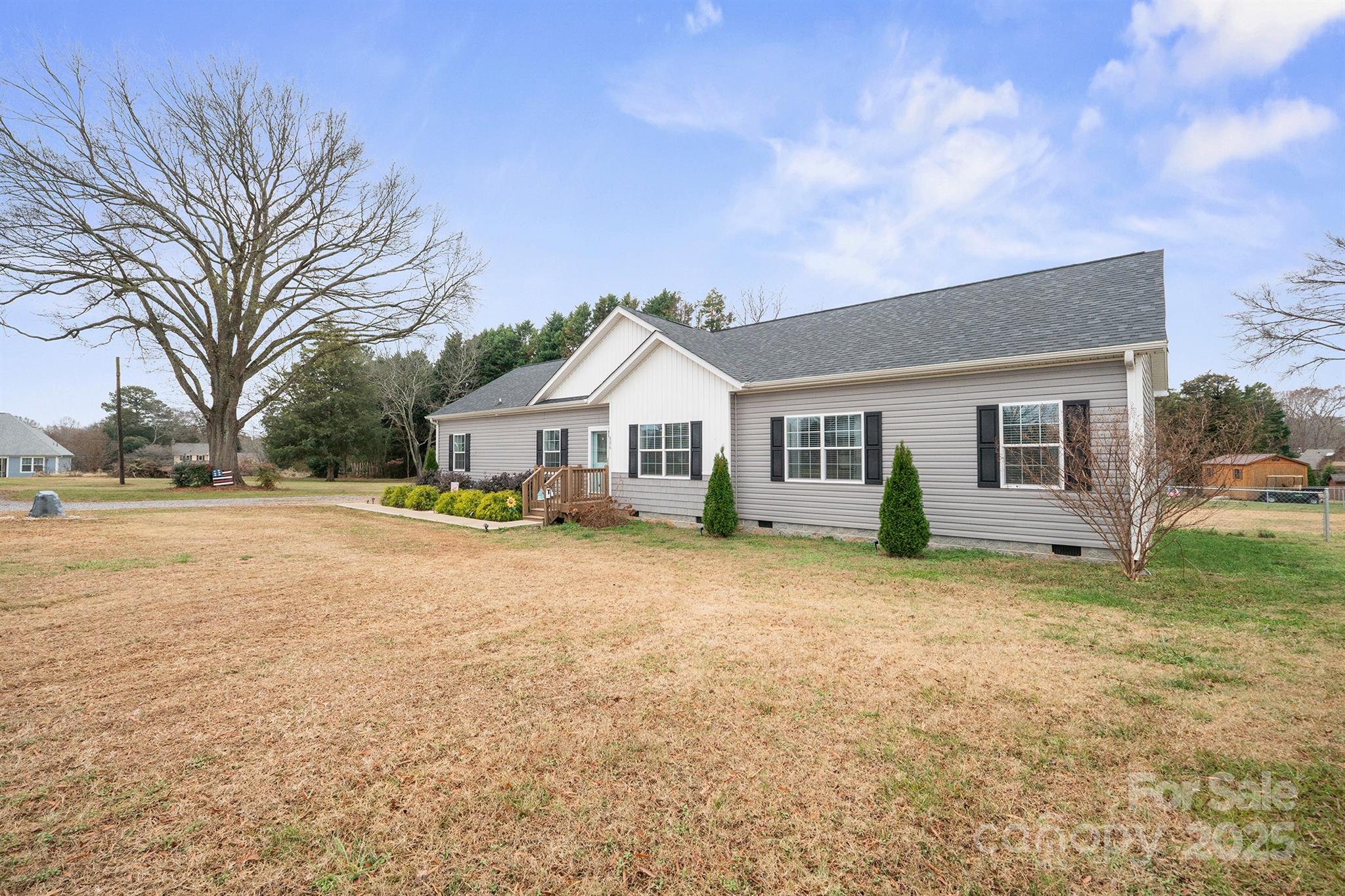 486 Stutts Road Mooresville, NC 28117 - Photo 2 of 35 a front view of house with yard and trees in the background