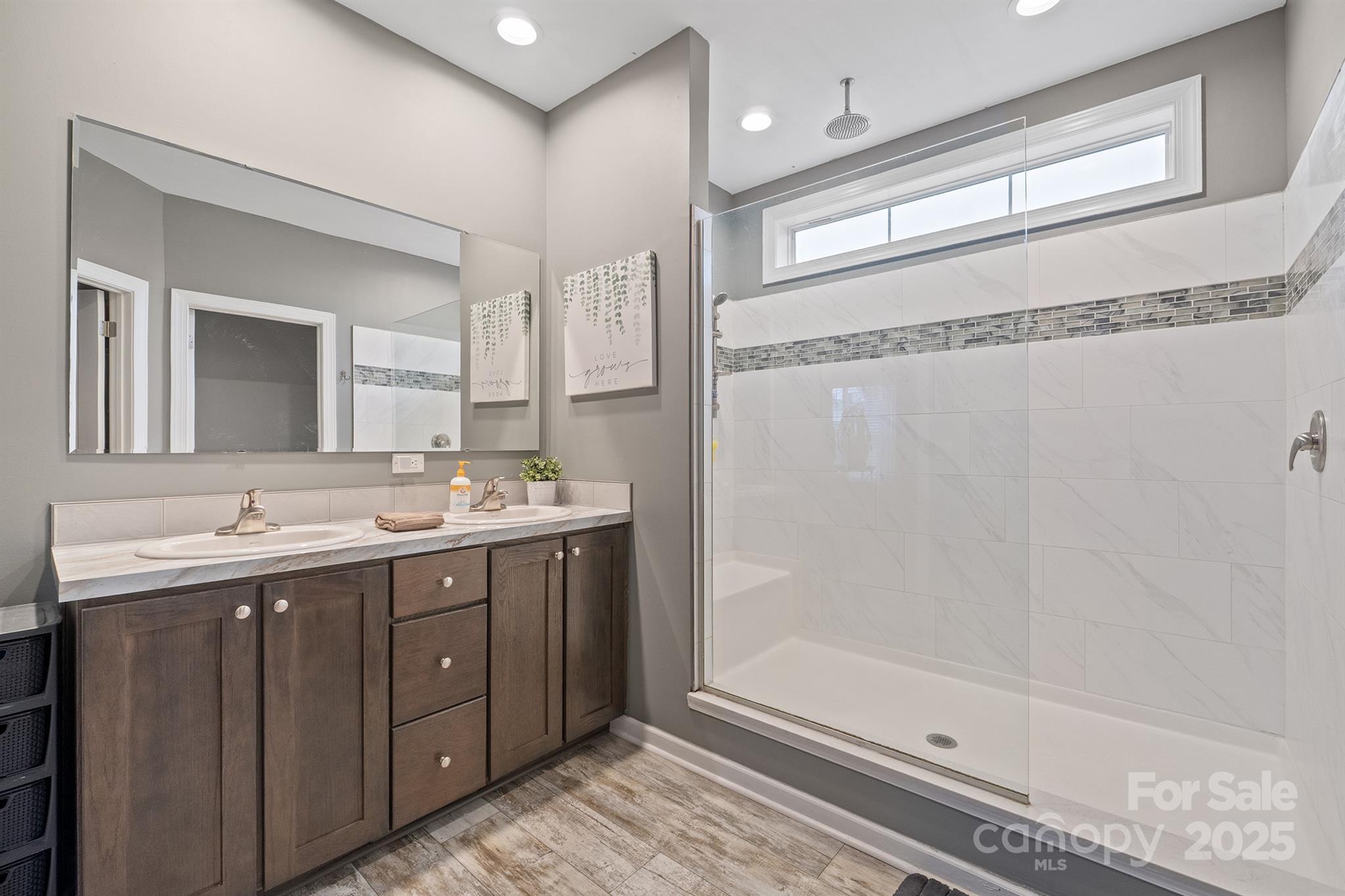 486 Stutts Road Mooresville, NC 28117 - Photo 22 of 35 a bathroom with a double vanity sink mirror and shower