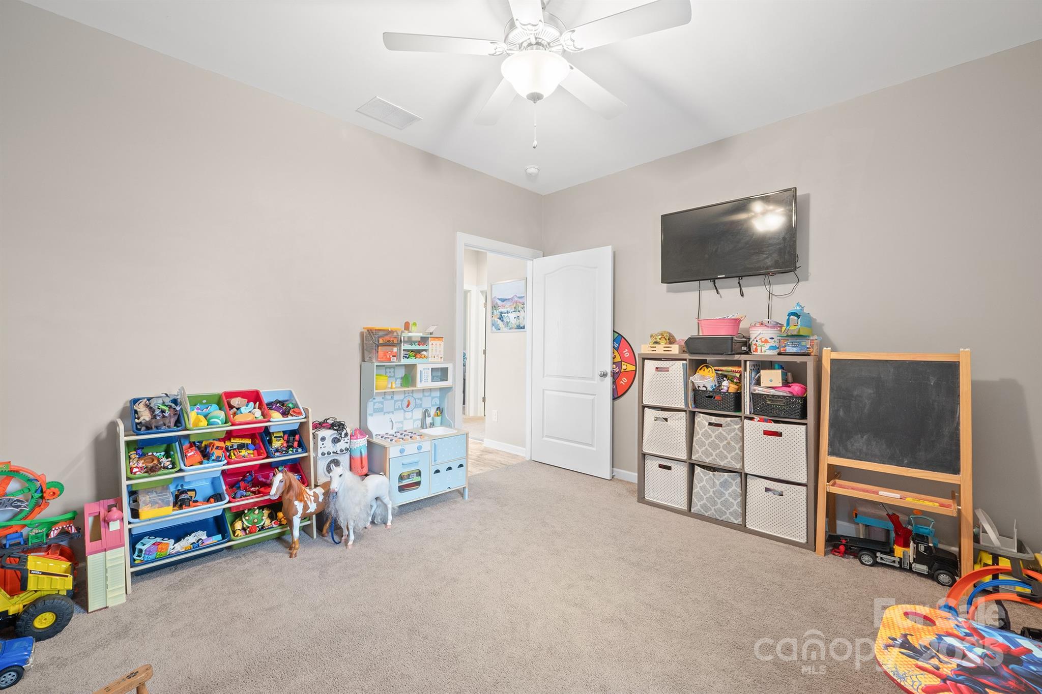 486 Stutts Road Mooresville, NC 28117 - Photo 28 of 35 a children room with toys and a flat screen tv