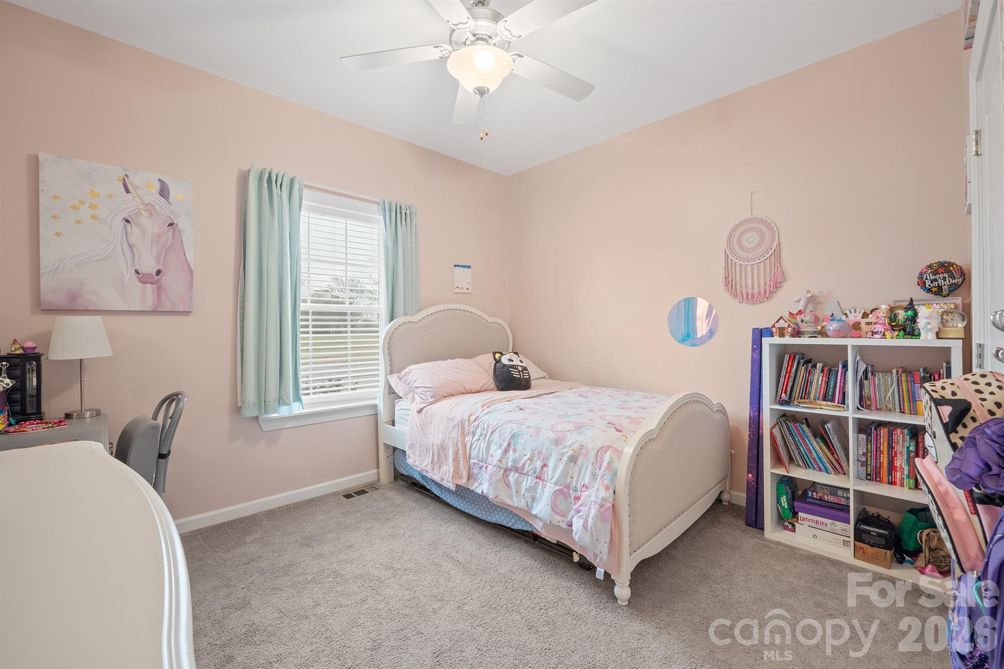 486 Stutts Road Mooresville, NC 28117 - Photo 28 of 35 a bed room with a bed and a book shelf