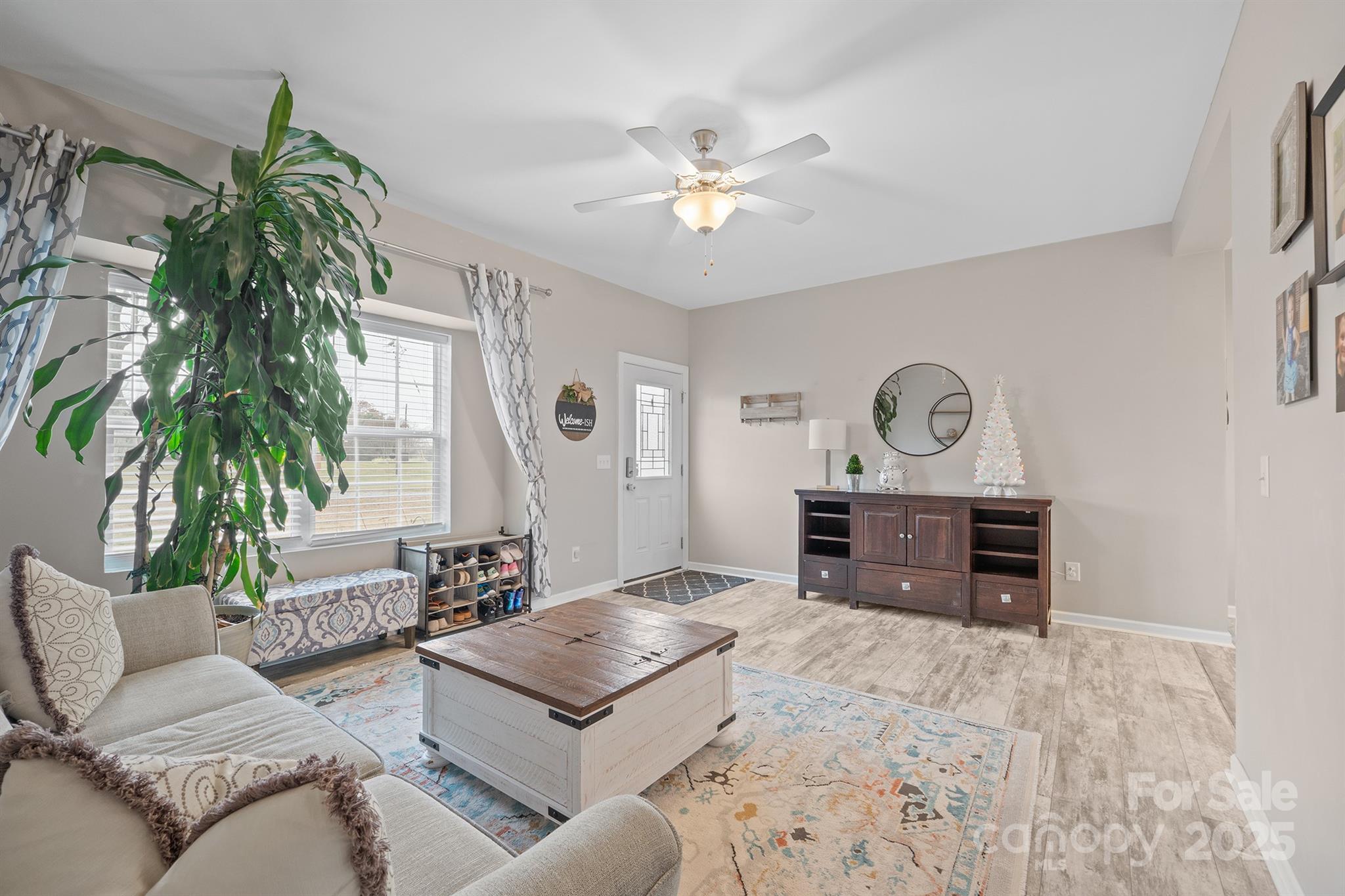 486 Stutts Road Mooresville, NC 28117 - Photo 5 of 35 a living room with furniture and a chandelier
