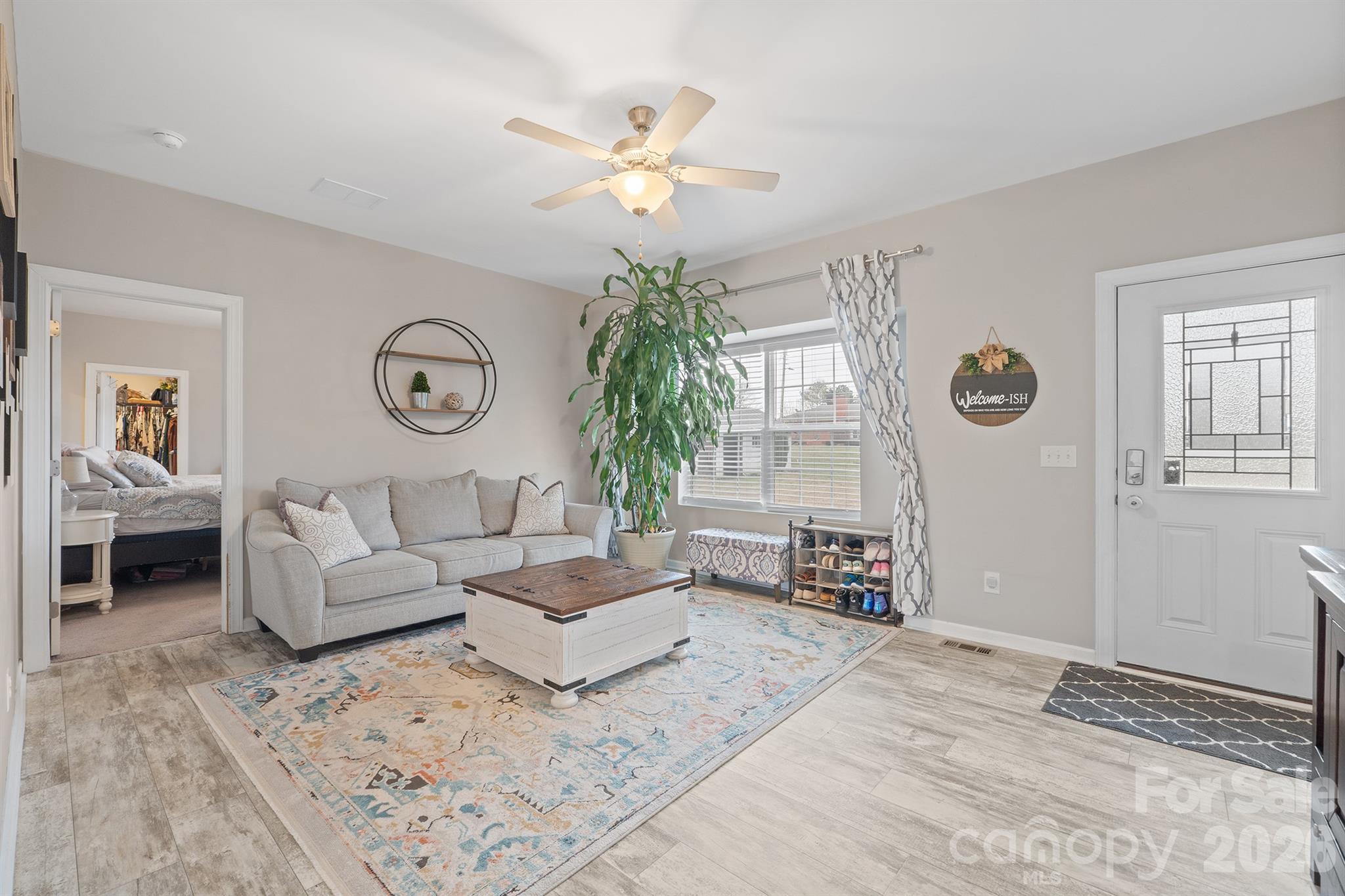 486 Stutts Road Mooresville, NC 28117 - Photo 5 of 35 a living room with furniture and a chandelier