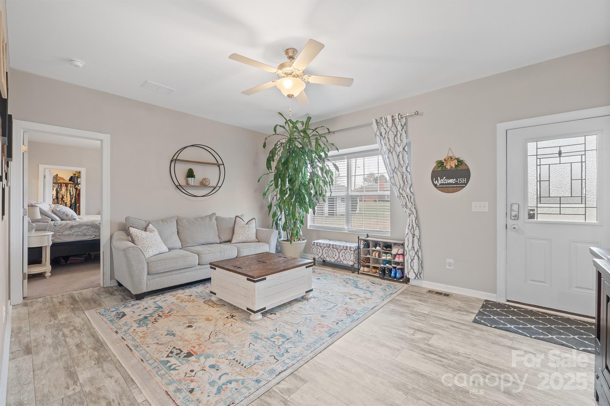 486 Stutts Road Mooresville, NC 28117 - Photo 6 of 35 a living room with furniture and a chandelier