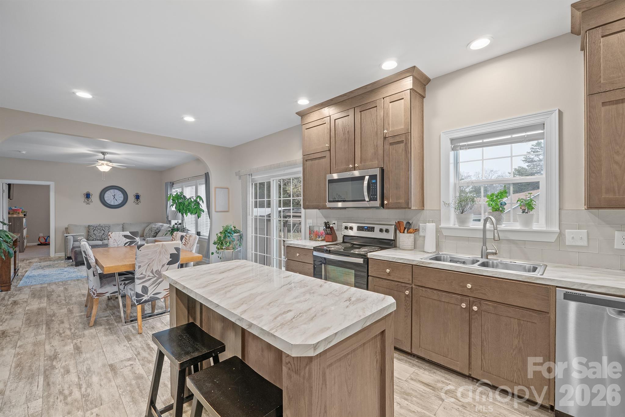 486 Stutts Road Mooresville, NC 28117 - Photo 10 of 35 a kitchen with a table chairs sink and cabinets
