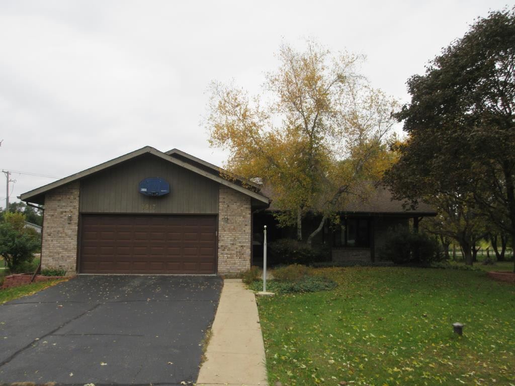 3917 Montclair Road Roscoe, IL 61073 - Photo 1 of 18 a front view of a house with garden