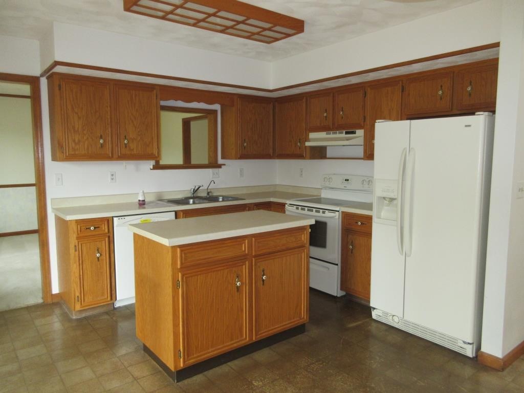 3917 Montclair Road Roscoe, IL 61073 - Photo 2 of 18 a kitchen with a sink a stove and a refrigerator