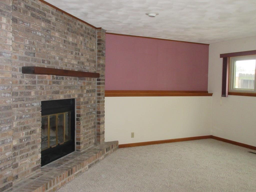 3917 Montclair Road Roscoe, IL 61073 - Photo 9 of 18 a view of an empty room with a fireplace