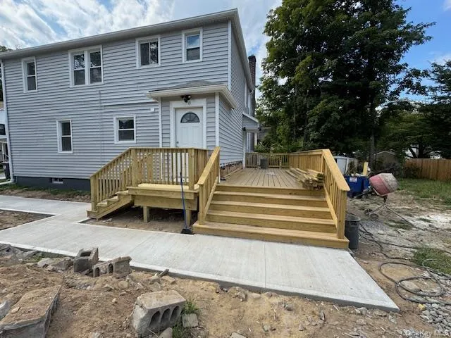 a view of a house with a yard and sitting area