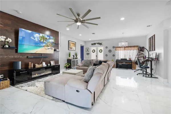 a living room with furniture and a flat screen tv