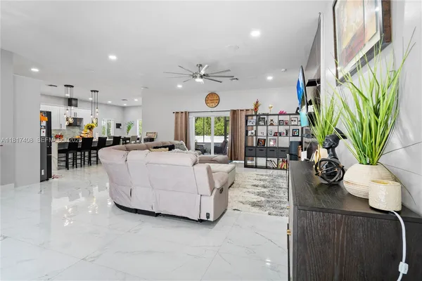 a living room with furniture potted plant and a table