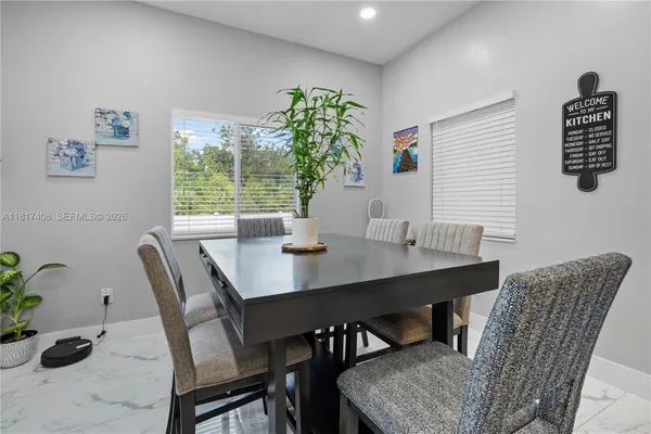 a view of a dining room with furniture window and outside view