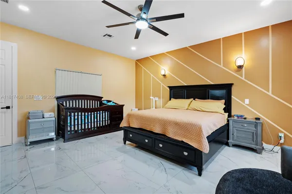 a bedroom with a bed and a ceiling fan