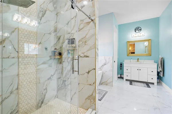 a bathroom with a double vanity sink toilet and shower