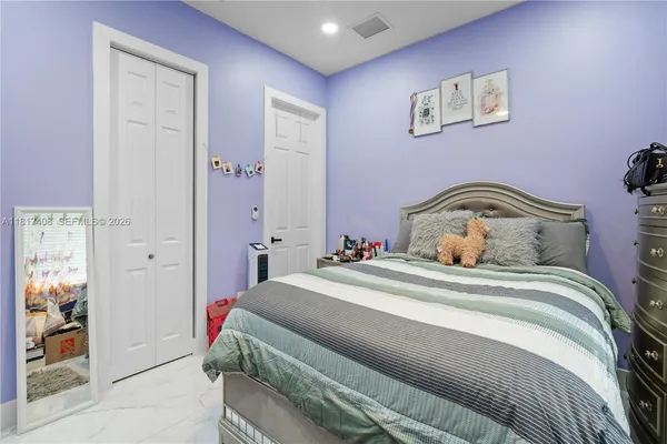 a bedroom with a bed and a mirror