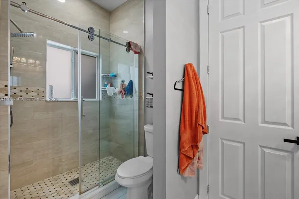 a bathroom with a shower and a toilet