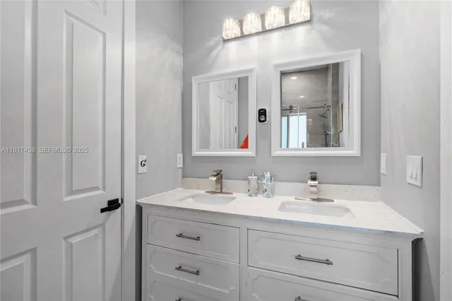 a bathroom with a double vanity sink and mirror