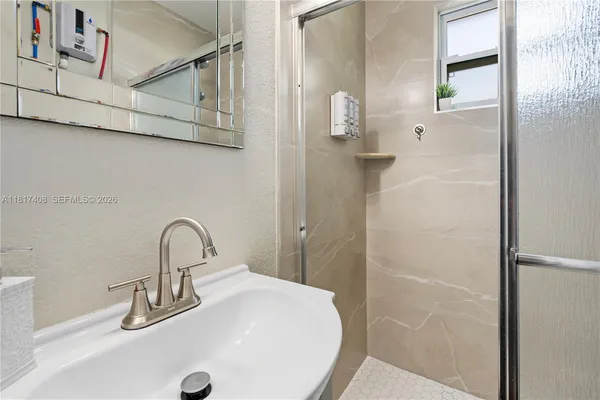a bathroom with a sink and mirror