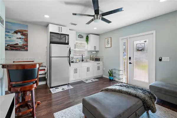 a spacious bedroom with a bed and a flat screen tv