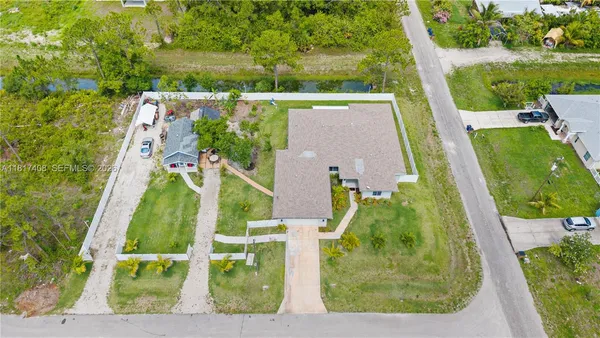 an aerial view of a house with a garden and houses