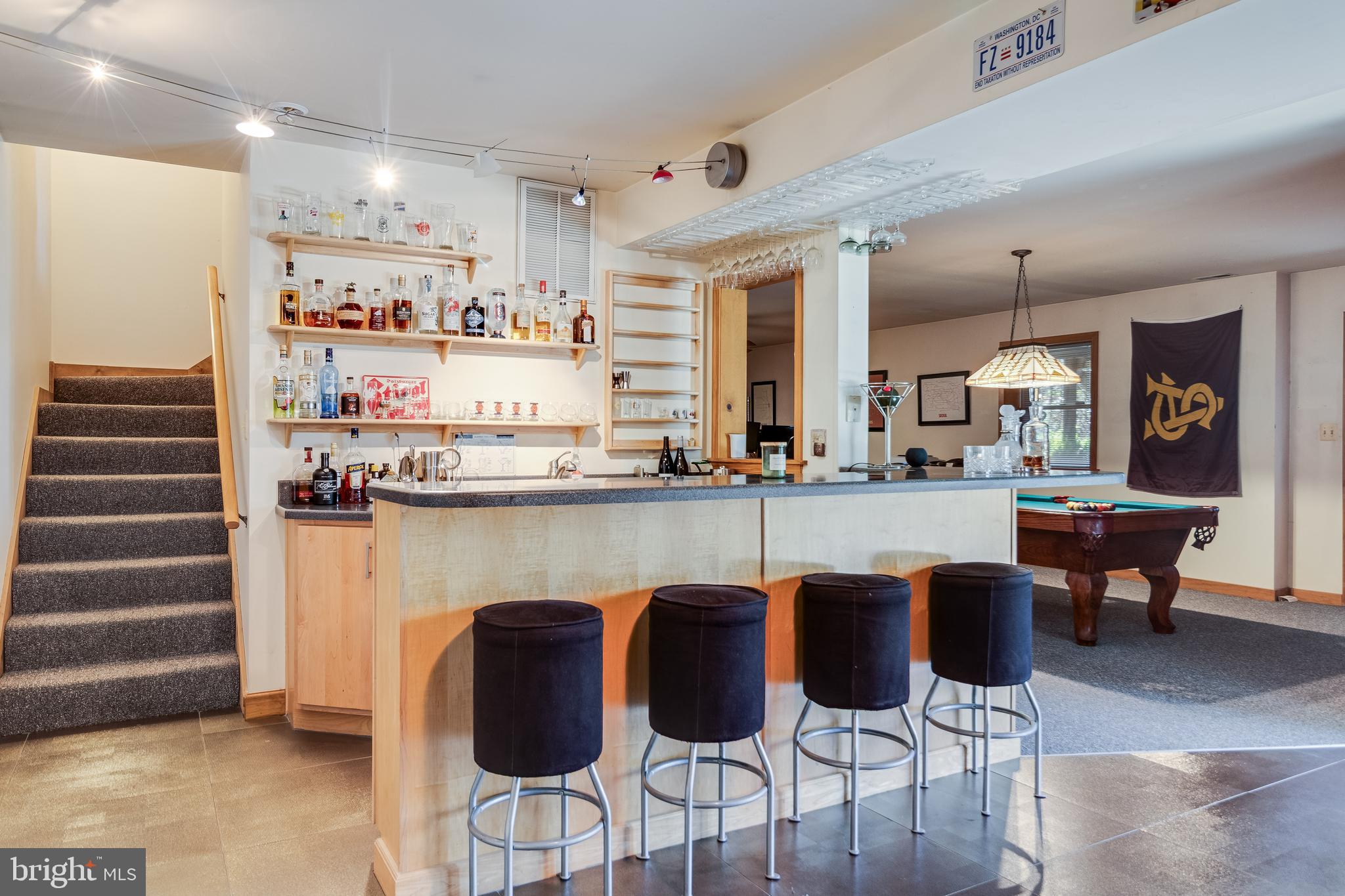 247 Frontier Trail Lusby, MD 20657 - Photo 18 of 62 a kitchen with stainless steel appliances granite countertop table chairs sink and cabinets