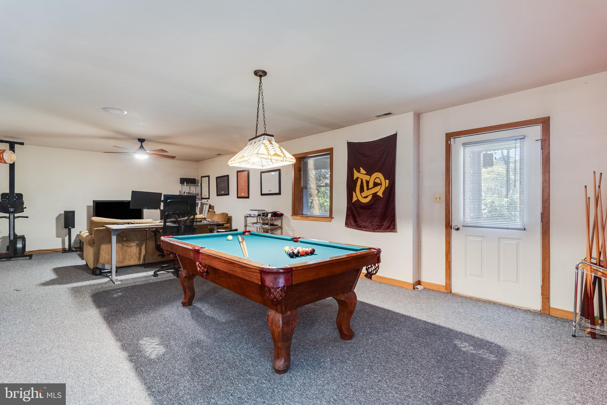 247 Frontier Trail Lusby, MD 20657 - Photo 20 of 62 a living room with furniture a table and kitchen view