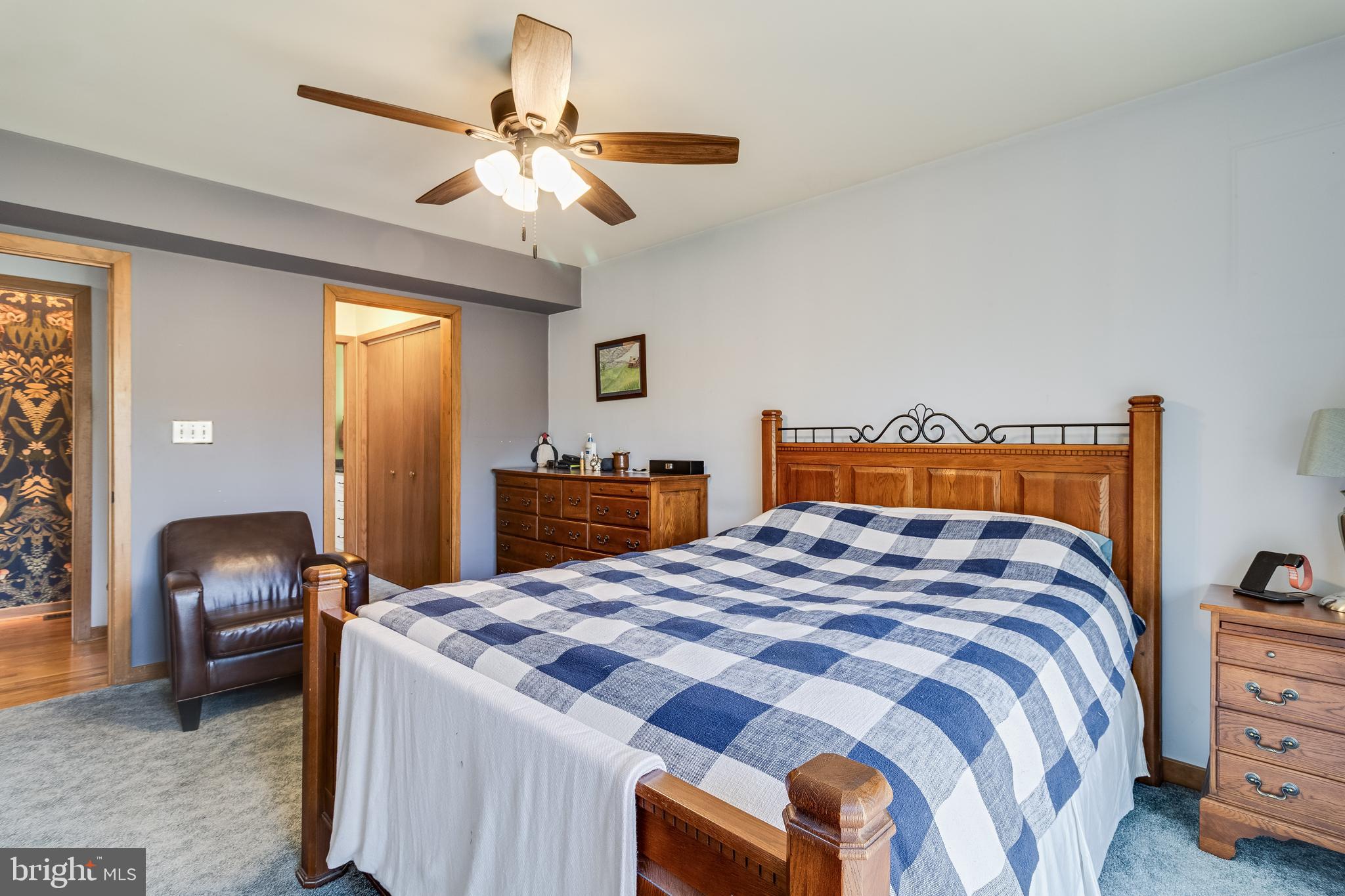 247 Frontier Trail Lusby, MD 20657 - Photo 24 of 62 a bedroom with a bed and a chandelier