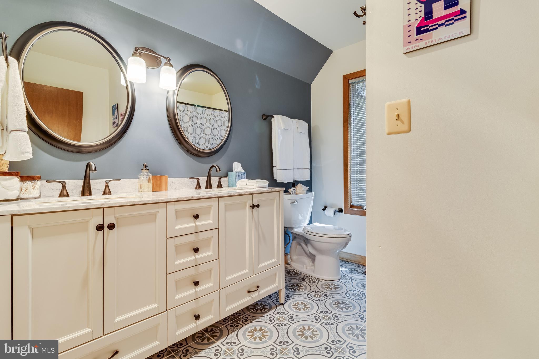 247 Frontier Trail Lusby, MD 20657 - Photo 25 of 62 a bathroom with a toilet a sink and a mirror