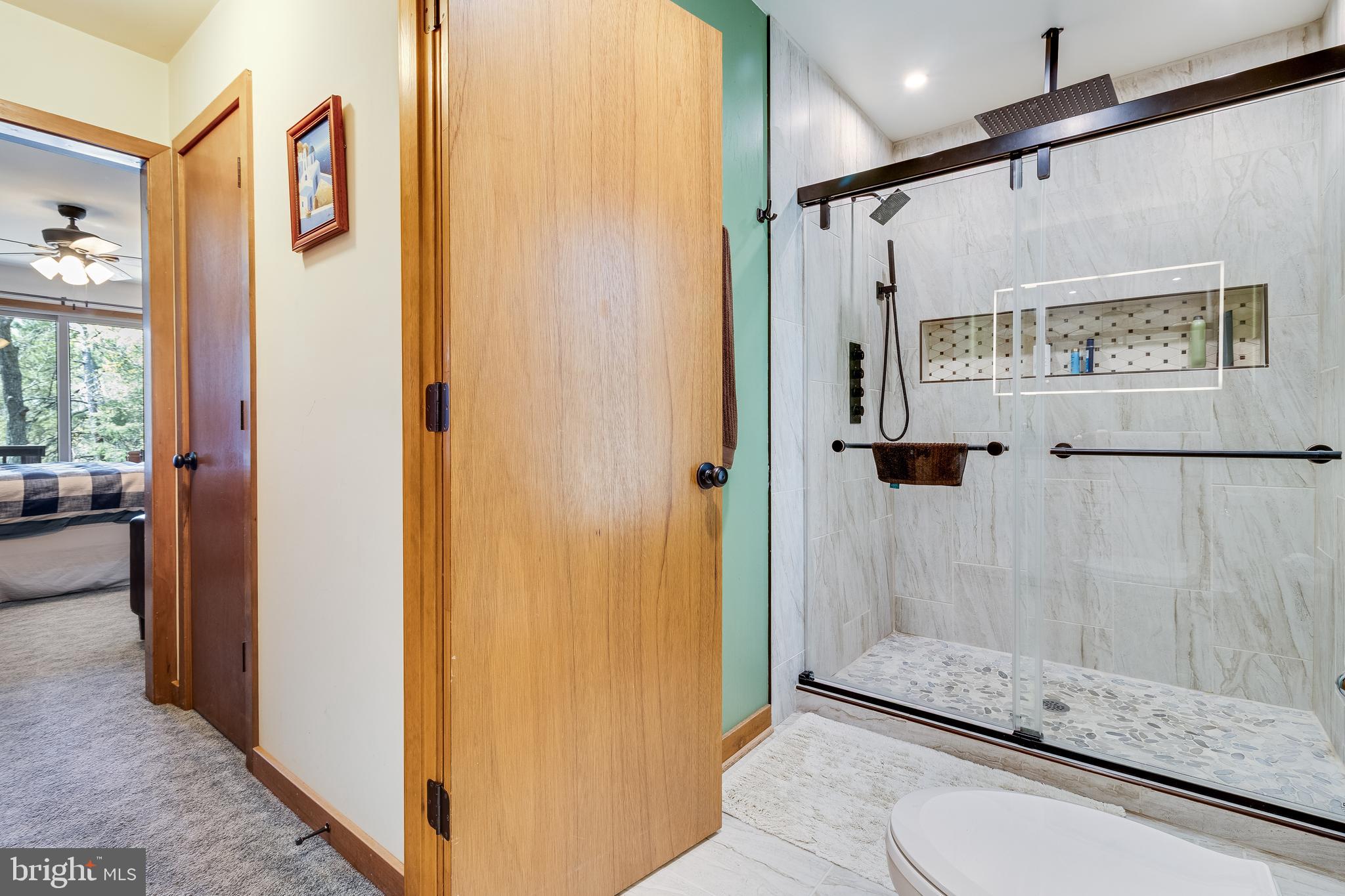 247 Frontier Trail Lusby, MD 20657 - Photo 27 of 62 a bathroom with a glass shower door