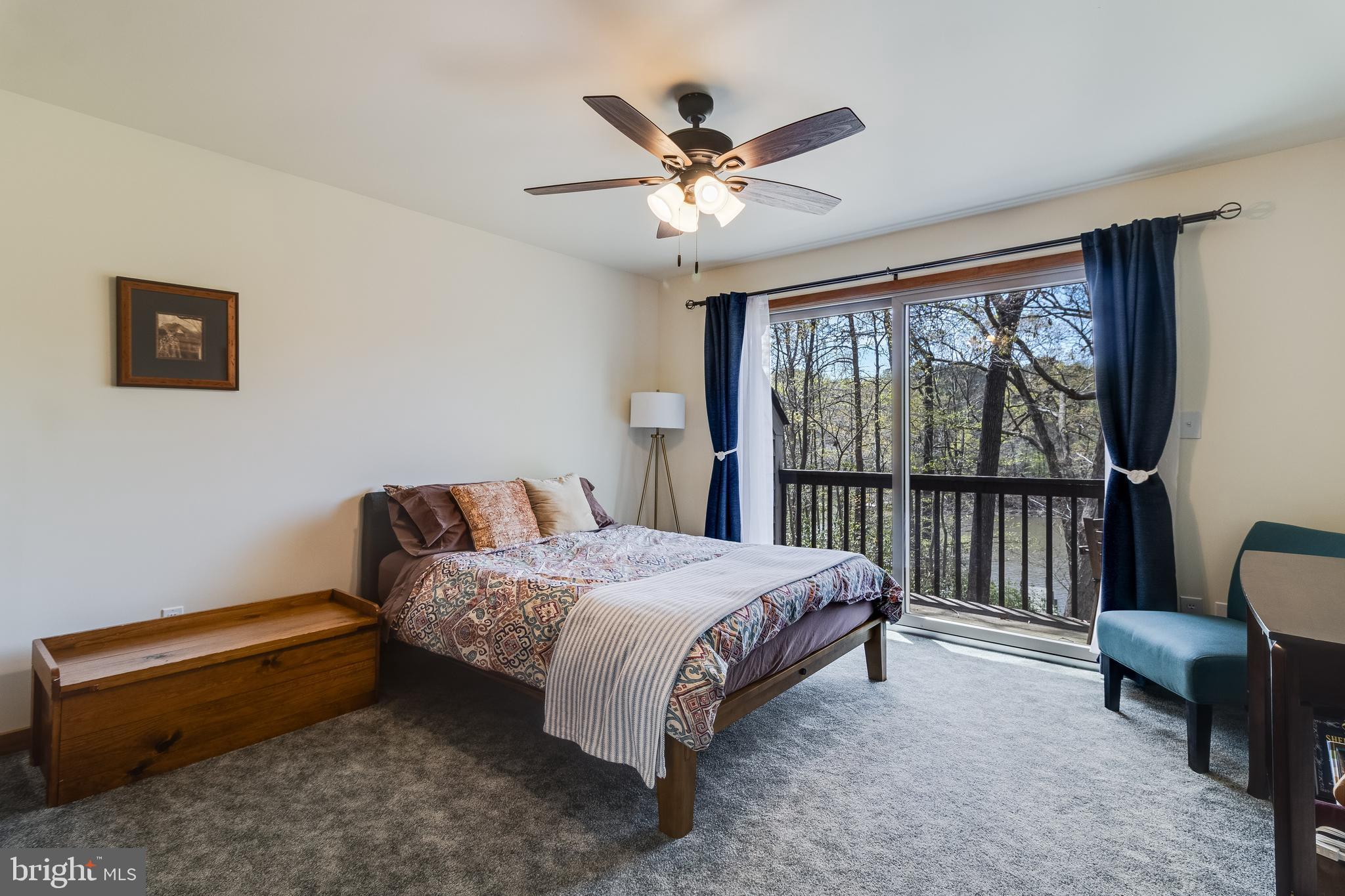 247 Frontier Trail Lusby, MD 20657 - Photo 28 of 62 a bedroom with a bed and a chandelier