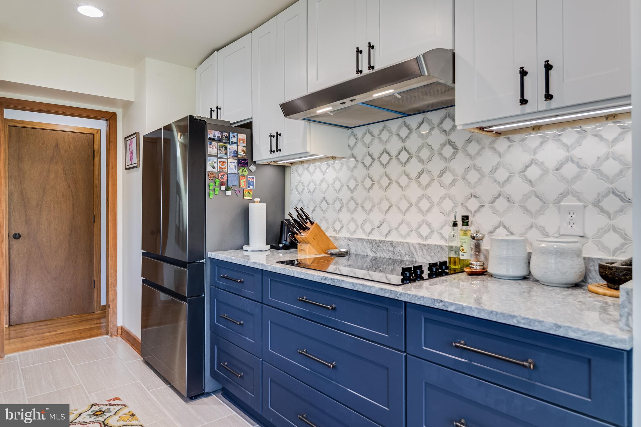 247 Frontier Trail Lusby, MD 20657 - Photo 37 of 62 a kitchen with stainless steel appliances granite countertop a refrigerator and a wooden floor