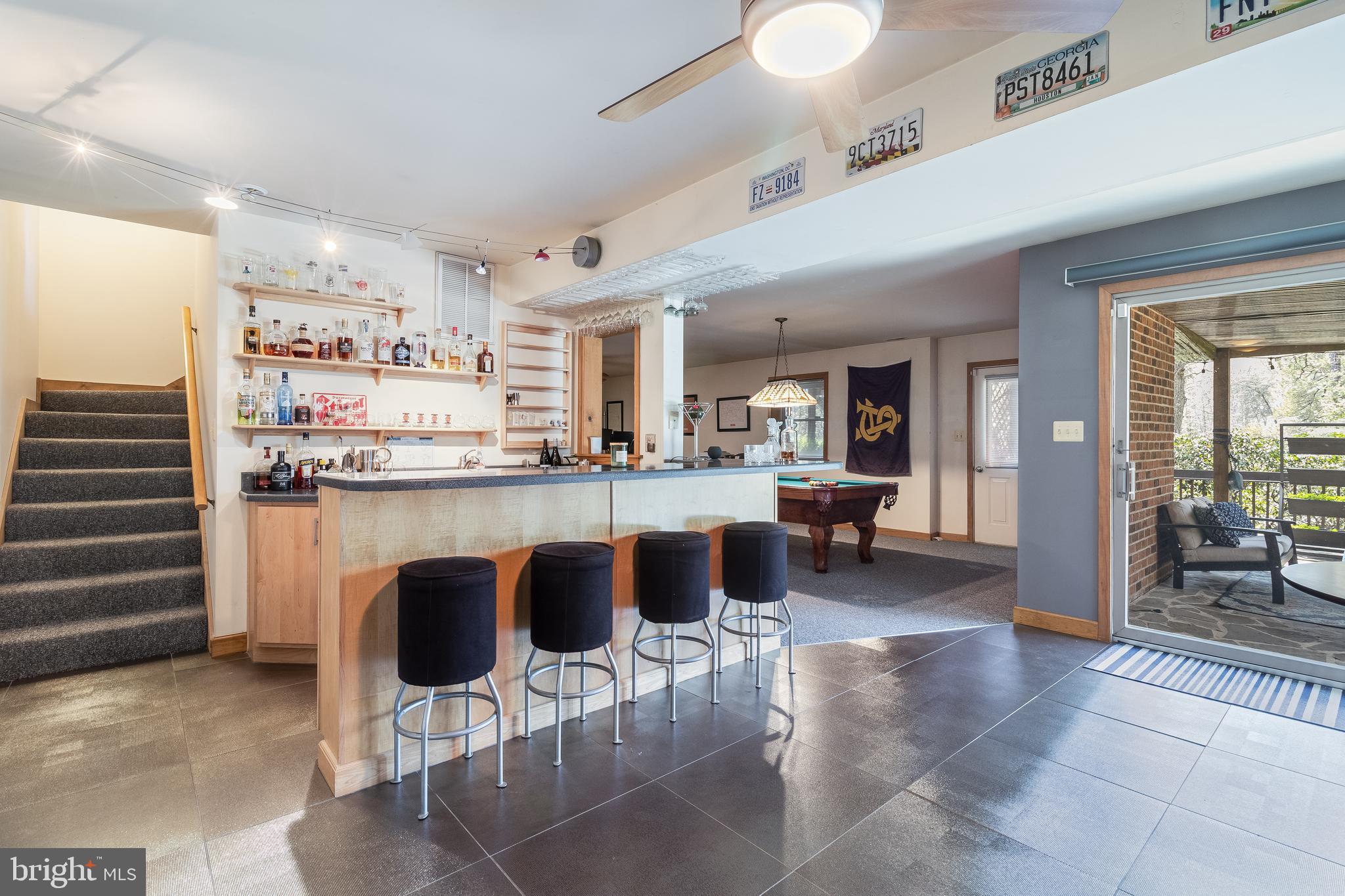 247 Frontier Trail Lusby, MD 20657 - Photo 39 of 62 a kitchen with stainless steel appliances kitchen island granite countertop a table and chairs in it