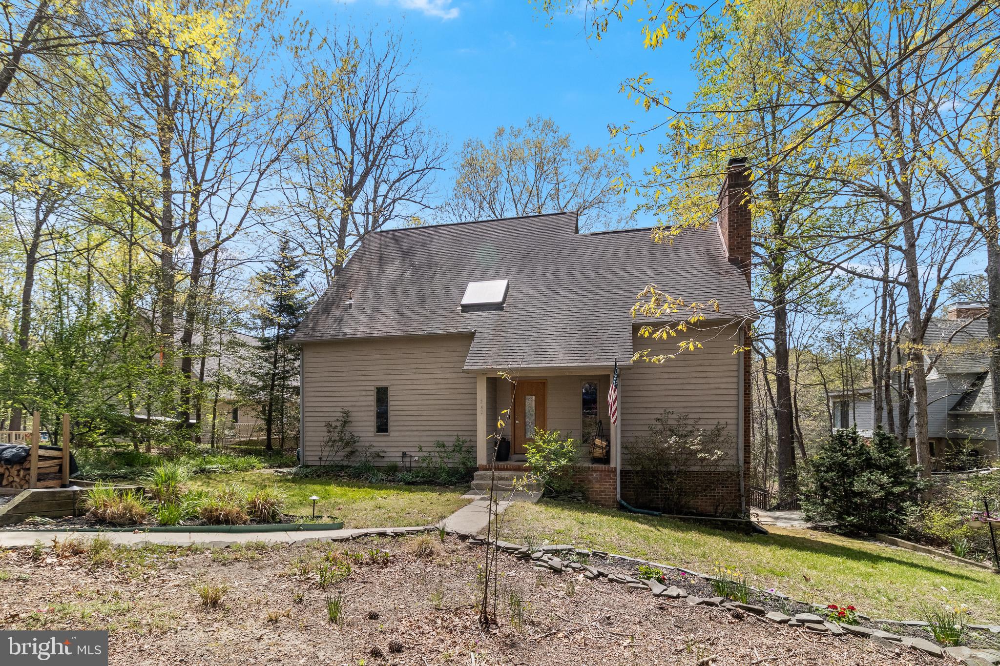 247 Frontier Trail Lusby, MD 20657 - Photo 59 of 62 a view of a house with a yard and large tree