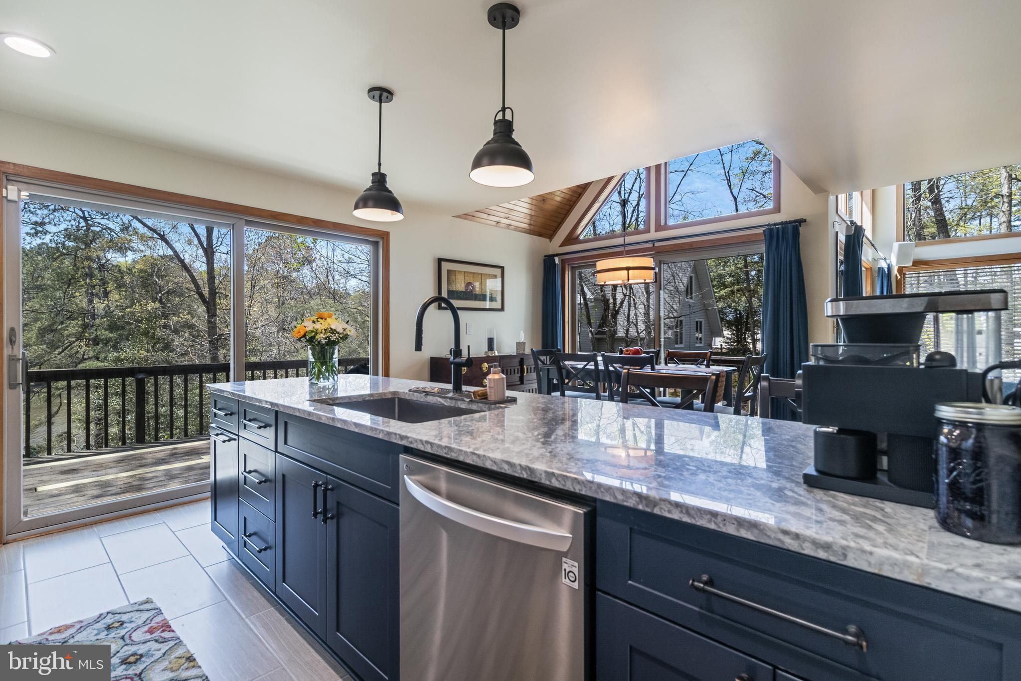 247 Frontier Trail Lusby, MD 20657 - Photo 7 of 62 a kitchen with stainless steel appliances granite countertop sink stove and wooden floor
