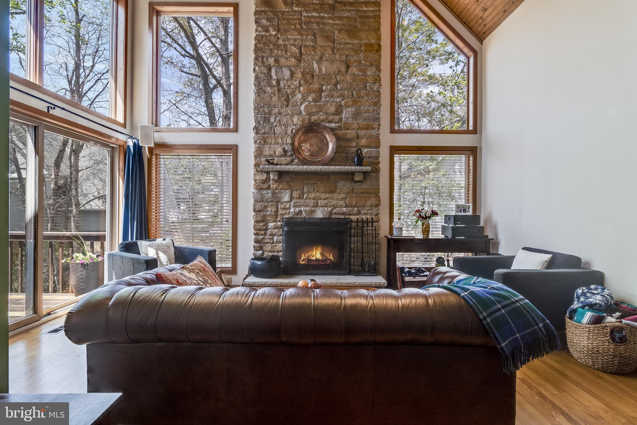 247 Frontier Trail Lusby, MD 20657 - Photo 10 of 62 a bedroom with a bed and a fireplace next to a window