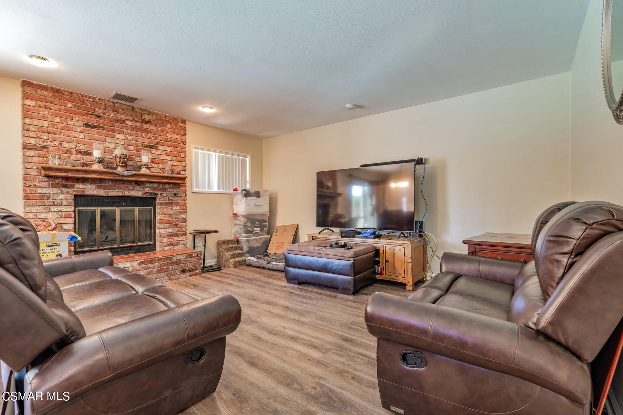 1765 Barnes Street Simi Valley, CA 93063 - Photo 18 of 30 a living room with furniture a flat screen tv and a fireplace