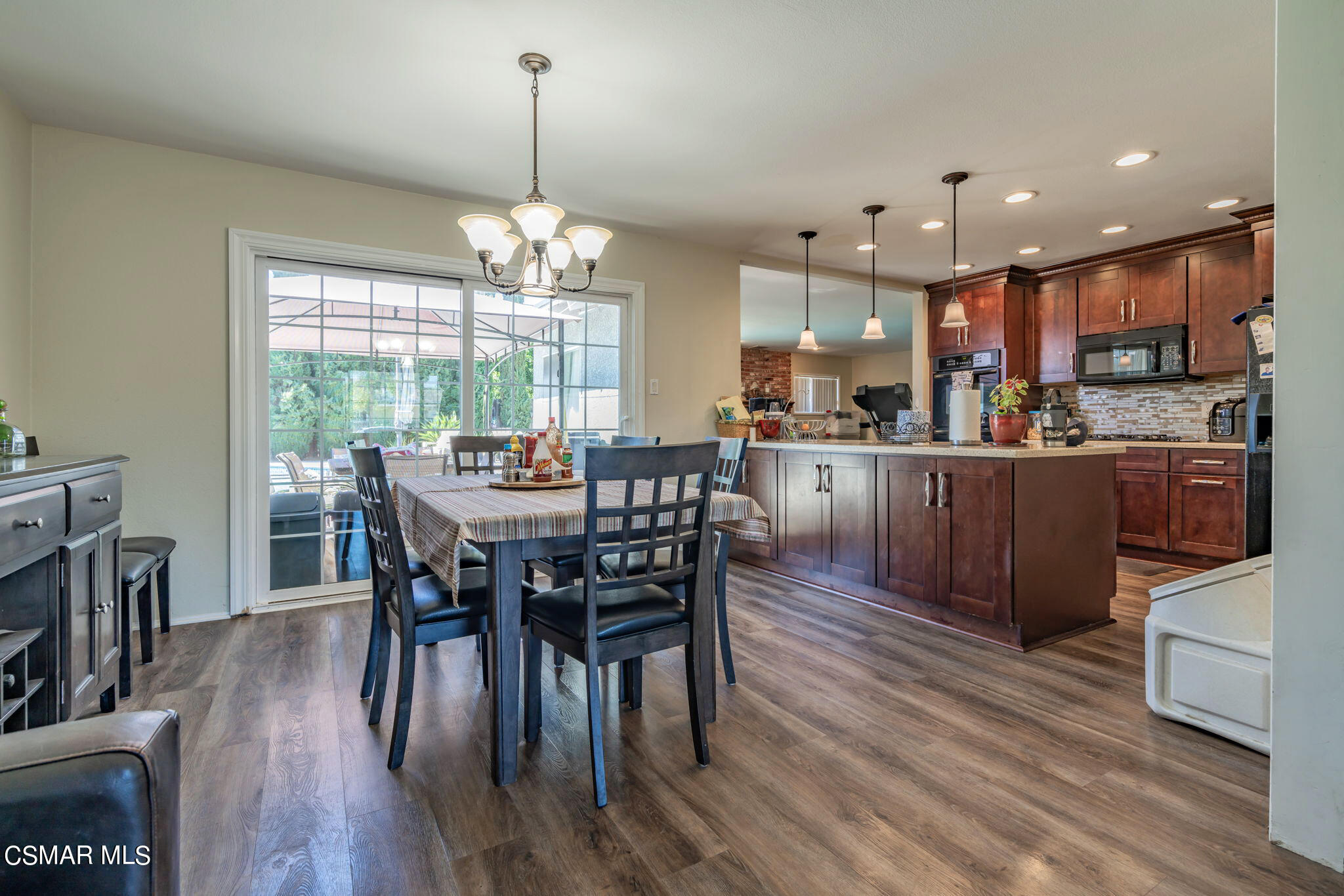 1765 Barnes Street Simi Valley, CA 93063 - Photo 6 of 30 a view of a dining room and livingroom with furniture wooden floor a chandelier