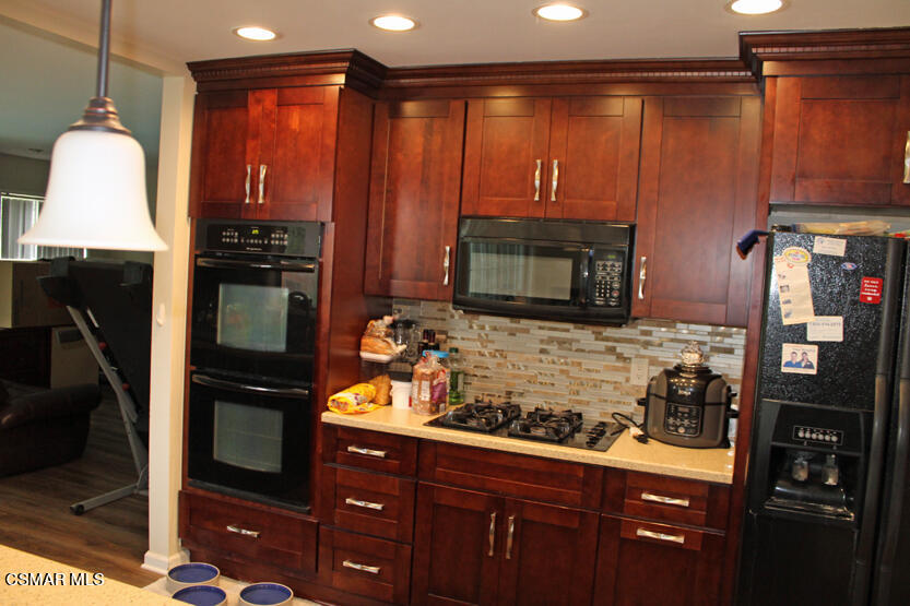 1765 Barnes Street Simi Valley, CA 93063 - Photo 8 of 30 a kitchen with a refrigerator and a microwave