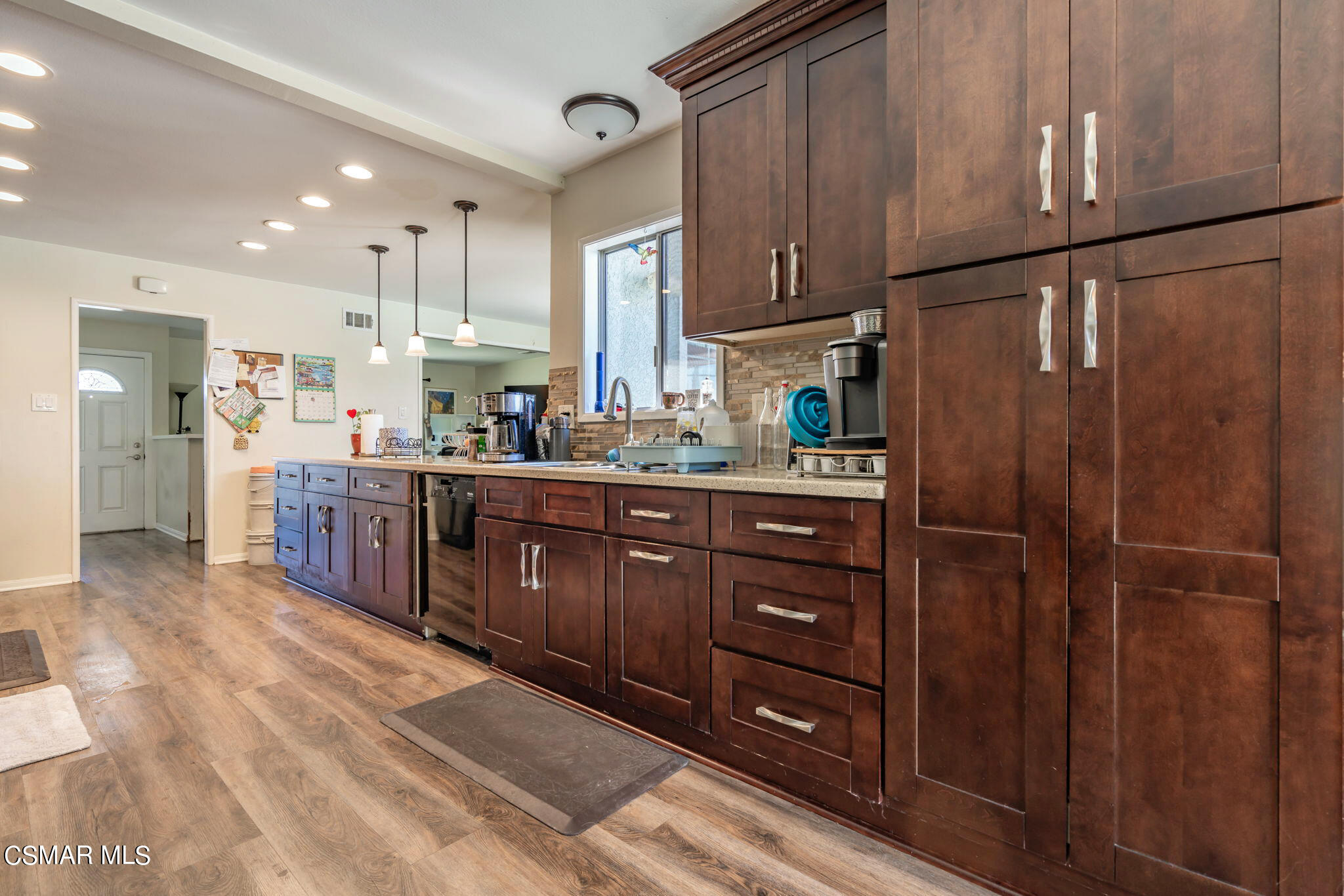 1765 Barnes Street Simi Valley, CA 93063 - Photo 10 of 30 a kitchen with stainless steel appliances granite countertop a refrigerator a sink dishwasher and wooden cabinets with wooden floor