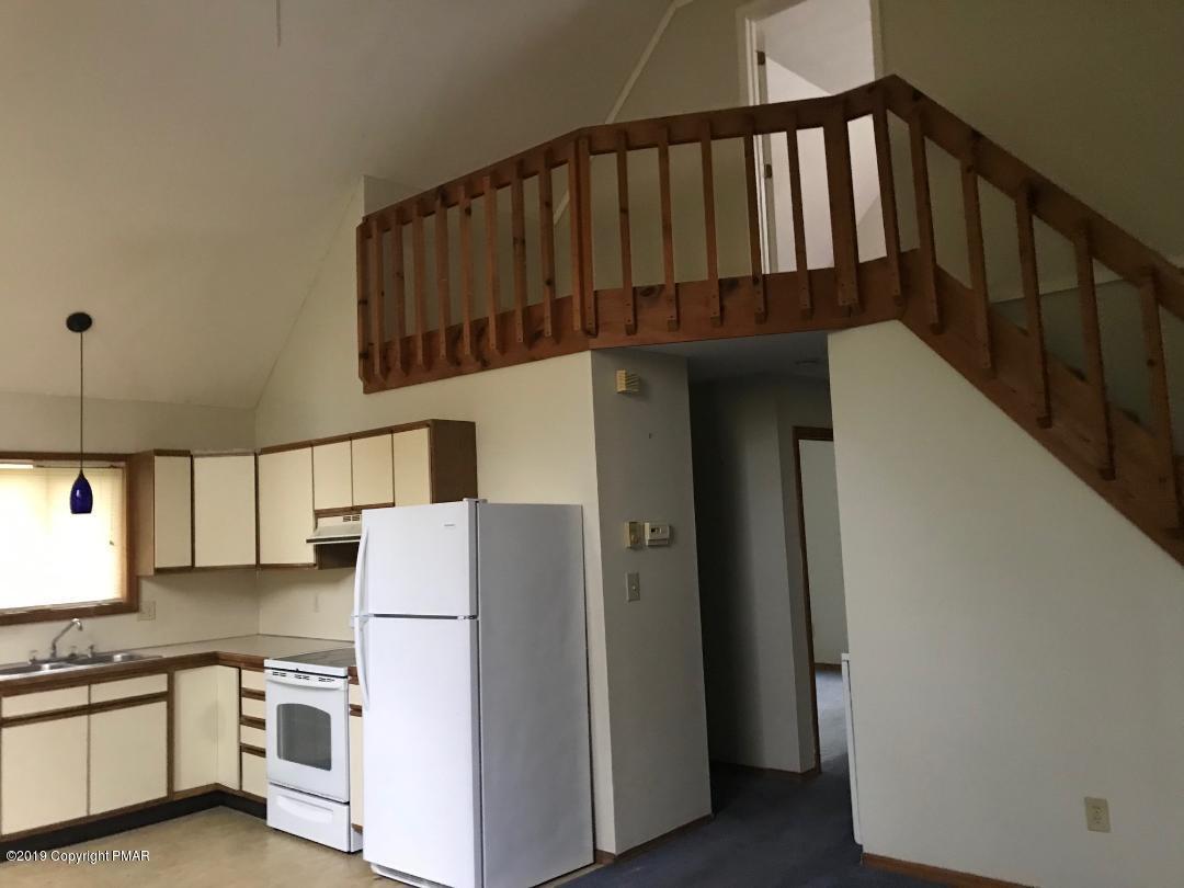 1129 Norfolk Road Tobyhanna, PA 18466 - Photo 6 of 14 a kitchen with a refrigerator and white cabinets