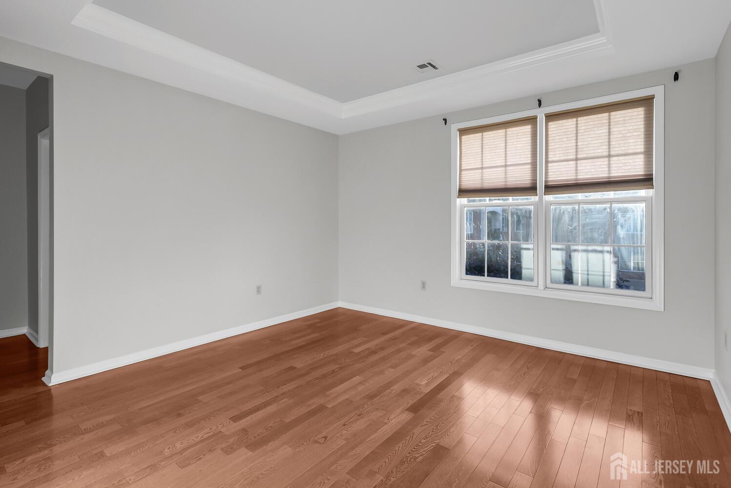 325 Regency Place Woodbridge, NJ 07095 - Photo 20 of 30 an empty room with wooden floor and windows