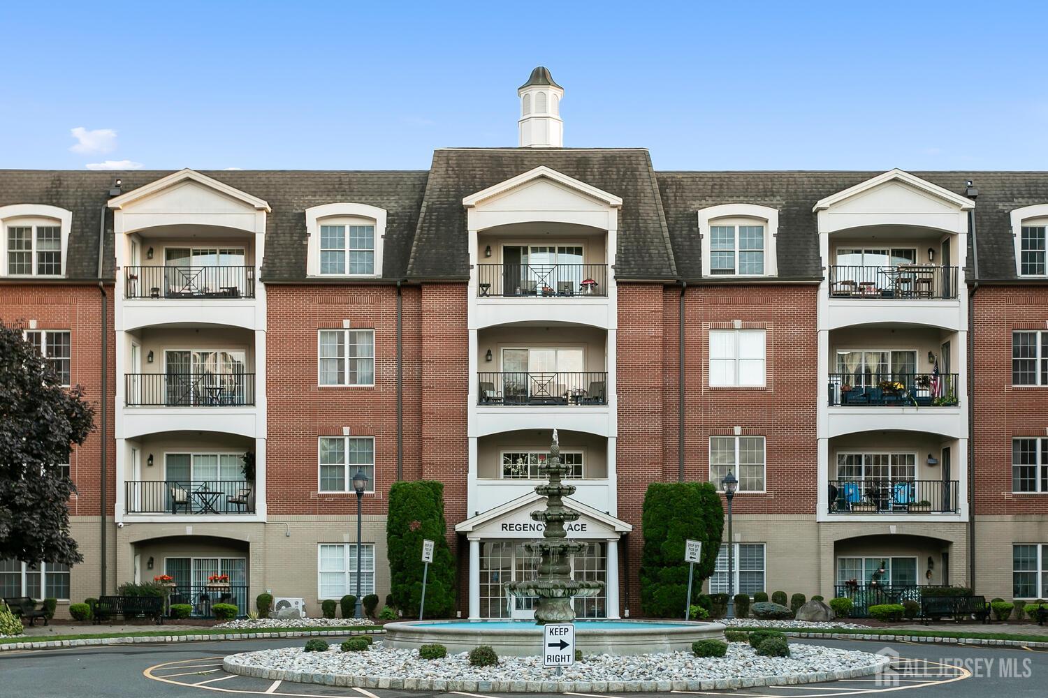 325 Regency Place Woodbridge, NJ 07095 - Photo 2 of 30 a front view of a building with a yard