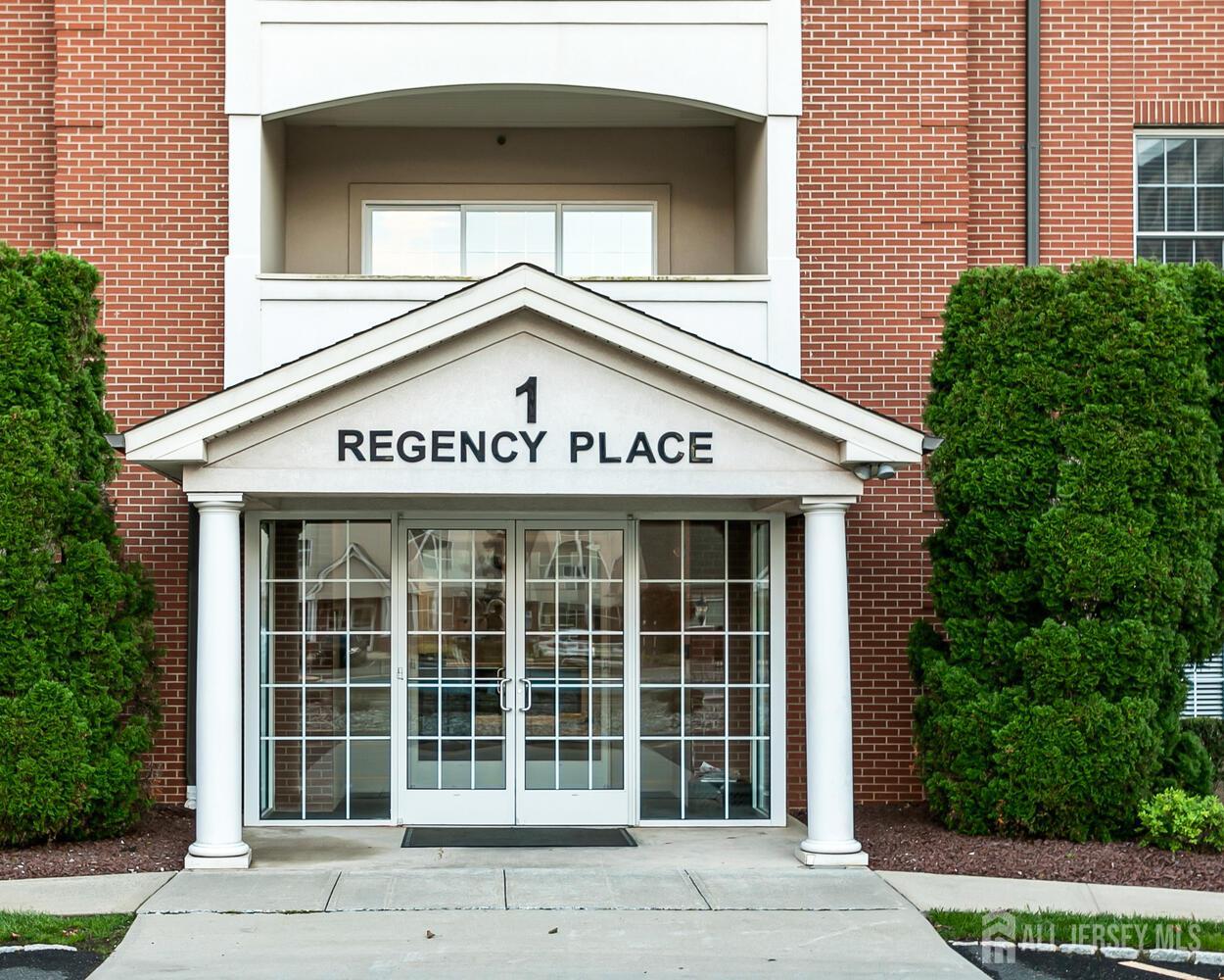 325 Regency Place Woodbridge, NJ 07095 - Photo 4 of 30 a sign on the side of a building