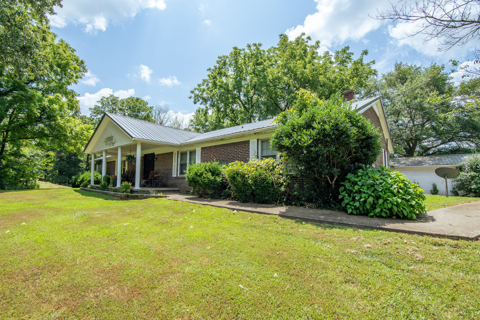 a front view of house with yard and green space
